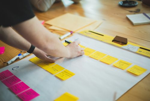 Photo by Brands&People person writing on white paper